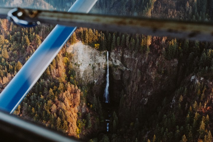 View of tall waterfall cascading over cliff in Oregon wilderness